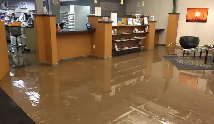 Standing water across the lobby floor of a flooded commercial office